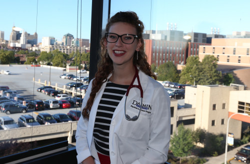 Female student in white medical jacket
